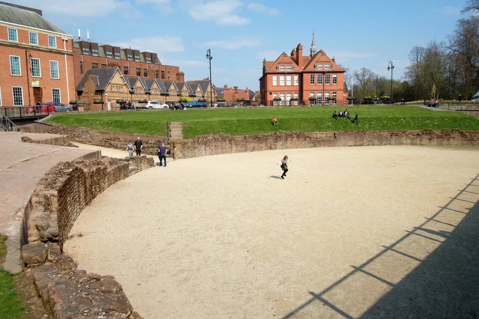 The excavated half of Chester Roman Amphitheatre today, with its stone walls and sand arena.