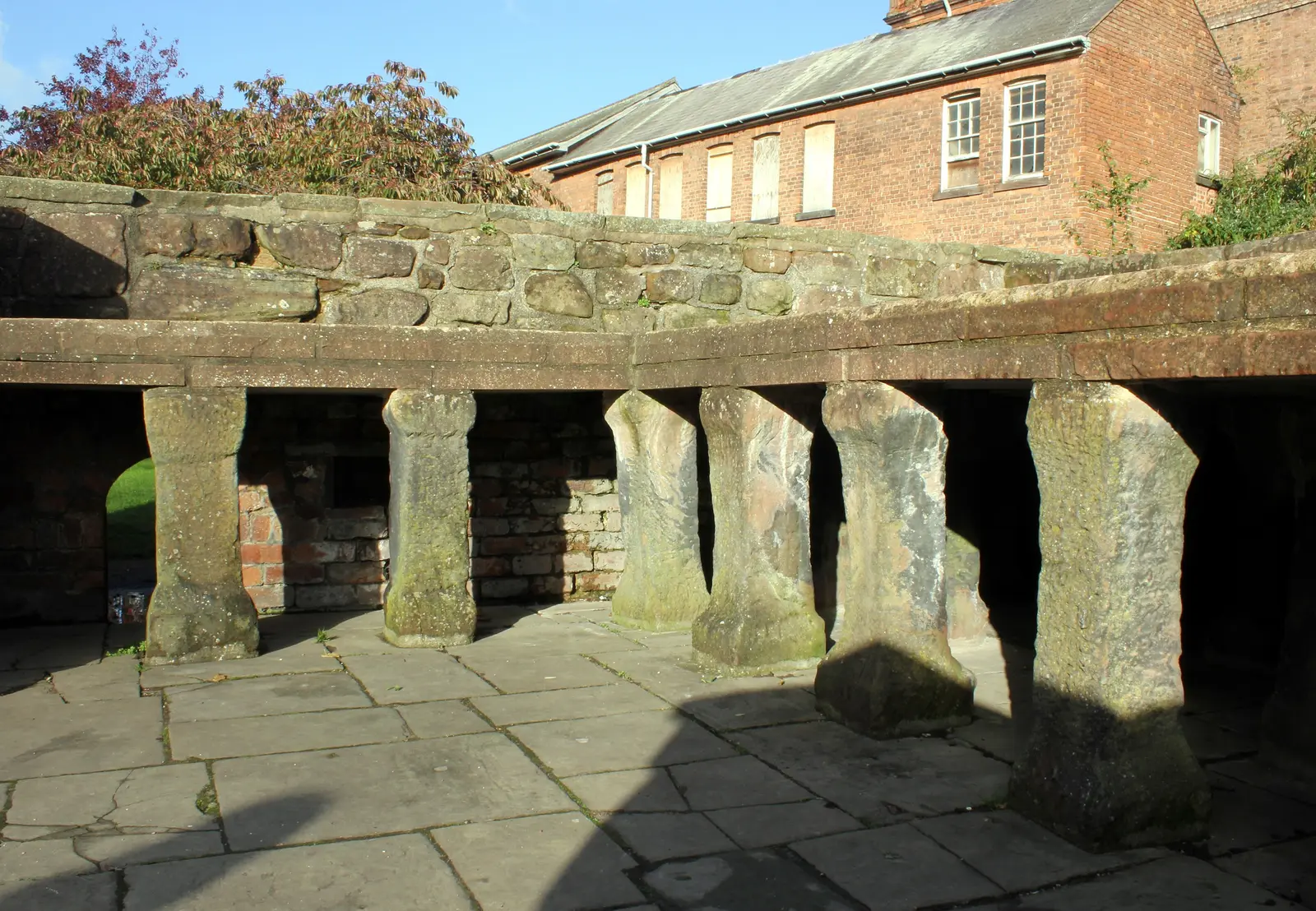 The reconstructed hypocaust in the Roman Gardens: rows of short stone pillars under a stone slab floor.