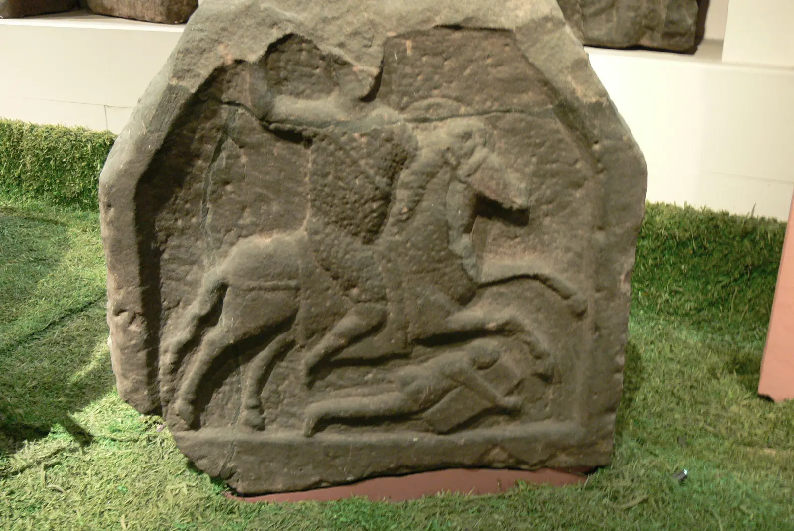 A Roman tombstone in the Grosvenor Museum carved with a cavalryman riding down a fallen enemy.
